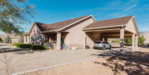 View of property exterior with a carport