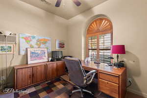 Carpeted office with ceiling fan