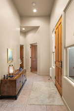 Hallway featuring light tile patterned floors