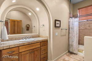 Bathroom with vanity and a shower with shower curtain