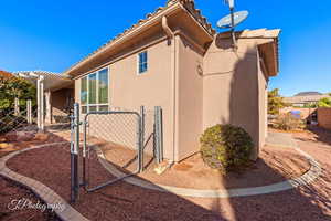 View of side of property with a pergola