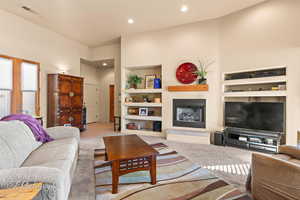 Living room featuring built in shelves