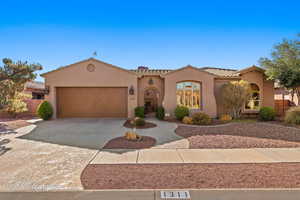 Mediterranean / spanish-style house with a garage