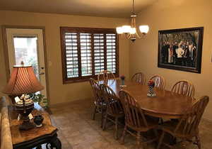 Dining area with a chandelier and vaulted ceiling