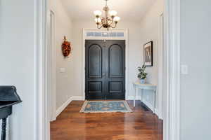 Foyer features transom over beautiful wood front door