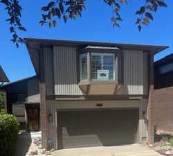View of front of home featuring a garage and concrete driveway