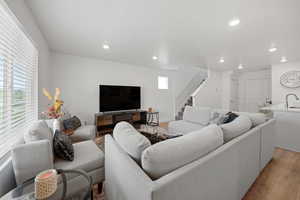 Living room featuring sink and light hardwood / wood-style flooring