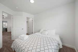 Carpeted bedroom with a spacious closet