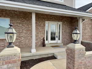 Doorway to property featuring a porch