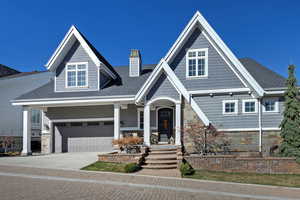 Craftsman-style house with covered porch and a garage