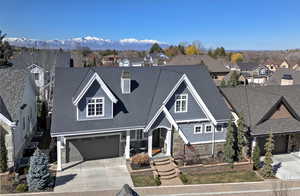 View of front of house with a mountain view and a garage