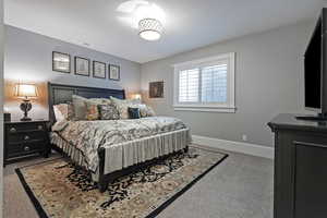 Bedroom featuring light colored carpet