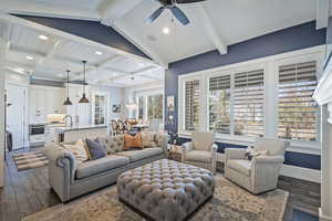 Living room featuring ceiling fan, beam ceiling, and dark hardwood / wood-style floors