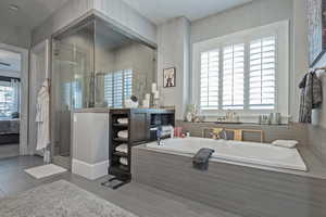 Bathroom featuring separate shower and tub and tile patterned flooring