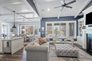 Living room featuring sink, ceiling fan, a wealth of natural light, and dark hardwood / wood-style flooring