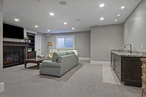 Living room with sink and light carpet