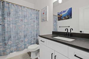 Bathroom with hardwood / wood-style flooring, toilet, vanity, and a shower with curtain