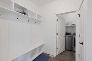 Mudroom featuring dark hardwood / wood-style floors and washer and dryer