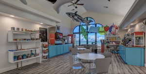 Dining area with vaulted ceiling, ceiling fan, and light hardwood / wood-style flooring