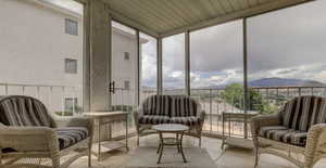 Sunroom / solarium featuring a mountain view