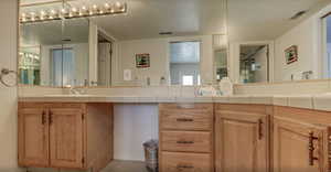 Bathroom with vanity, tile patterned floors, and a textured ceiling