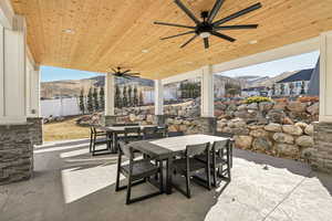 View of patio / terrace with ceiling fan and a mountain view