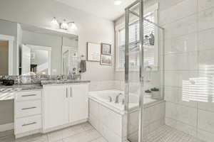 Bathroom featuring vanity and shower with separate bathtub