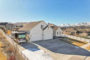 View of front of property with a mountain view and a garage