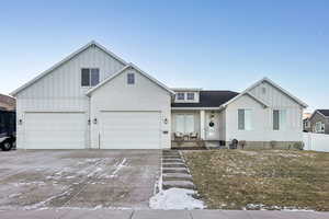 View of front of home with a garage and covered porch