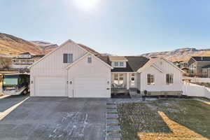 View of front of property with a mountain view and a garage