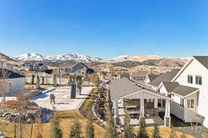 Back of house with a mountain view and a patio