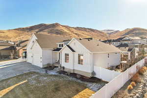 View of front of property with a mountain view and central AC unit