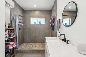 Bathroom with vanity and a tile shower