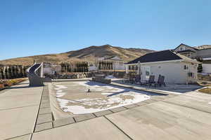 View of swimming pool with a mountain view and a patio