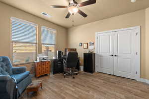 Office space featuring ceiling fan and light wood-type flooring