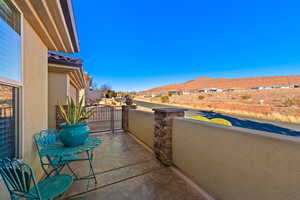 View of patio with a balcony and a mountain view