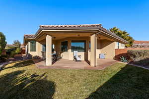 Back of property with a patio and a yard