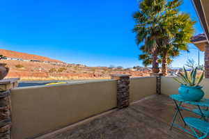 View of patio with a balcony