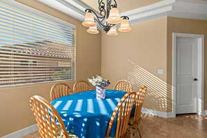 Dining room featuring a notable chandelier and tile patterned flooring