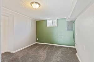 Interior space featuring a textured ceiling and electric panel