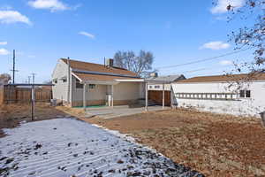 Snow covered property with a patio area and cooling unit