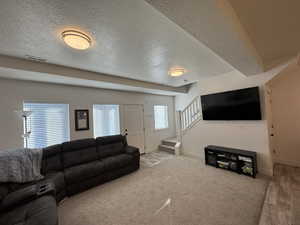 Living room with wood-type flooring and a textured ceiling