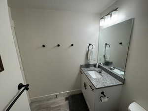 Bathroom with vanity, toilet, and a textured ceiling