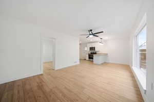 Unfurnished living room featuring light hardwood / wood-style floors and ceiling fan