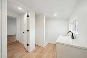 Bathroom with hardwood / wood-style flooring and vanity