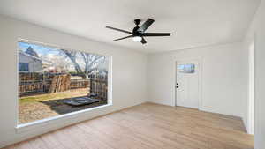 Empty room featuring light wood-type flooring and ceiling fan