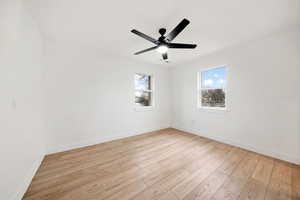 Unfurnished room featuring ceiling fan and light hardwood / wood-style flooring