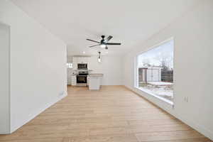 Unfurnished living room with ceiling fan, light hardwood / wood-style floors, and plenty of natural light