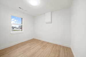 Unfurnished room featuring light wood-type flooring