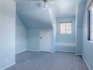 Bonus room with lofted ceiling, carpet floors, and ceiling fan